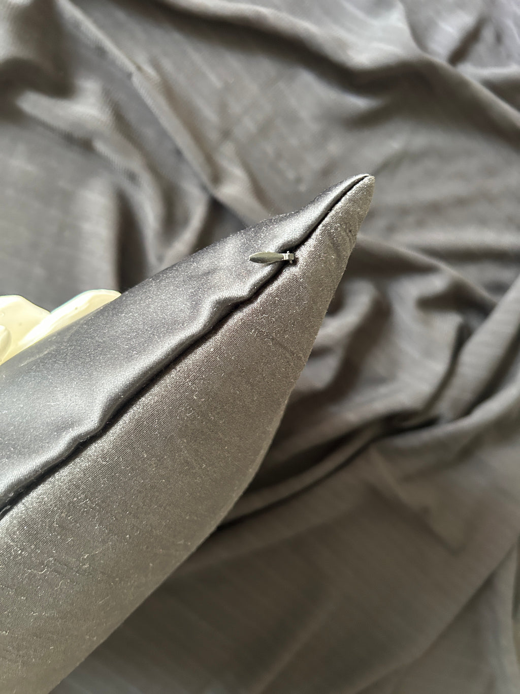 Close-up of a textured black fabric with a focus on a corner.