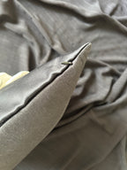 Close-up of a textured black fabric with a focus on a corner.