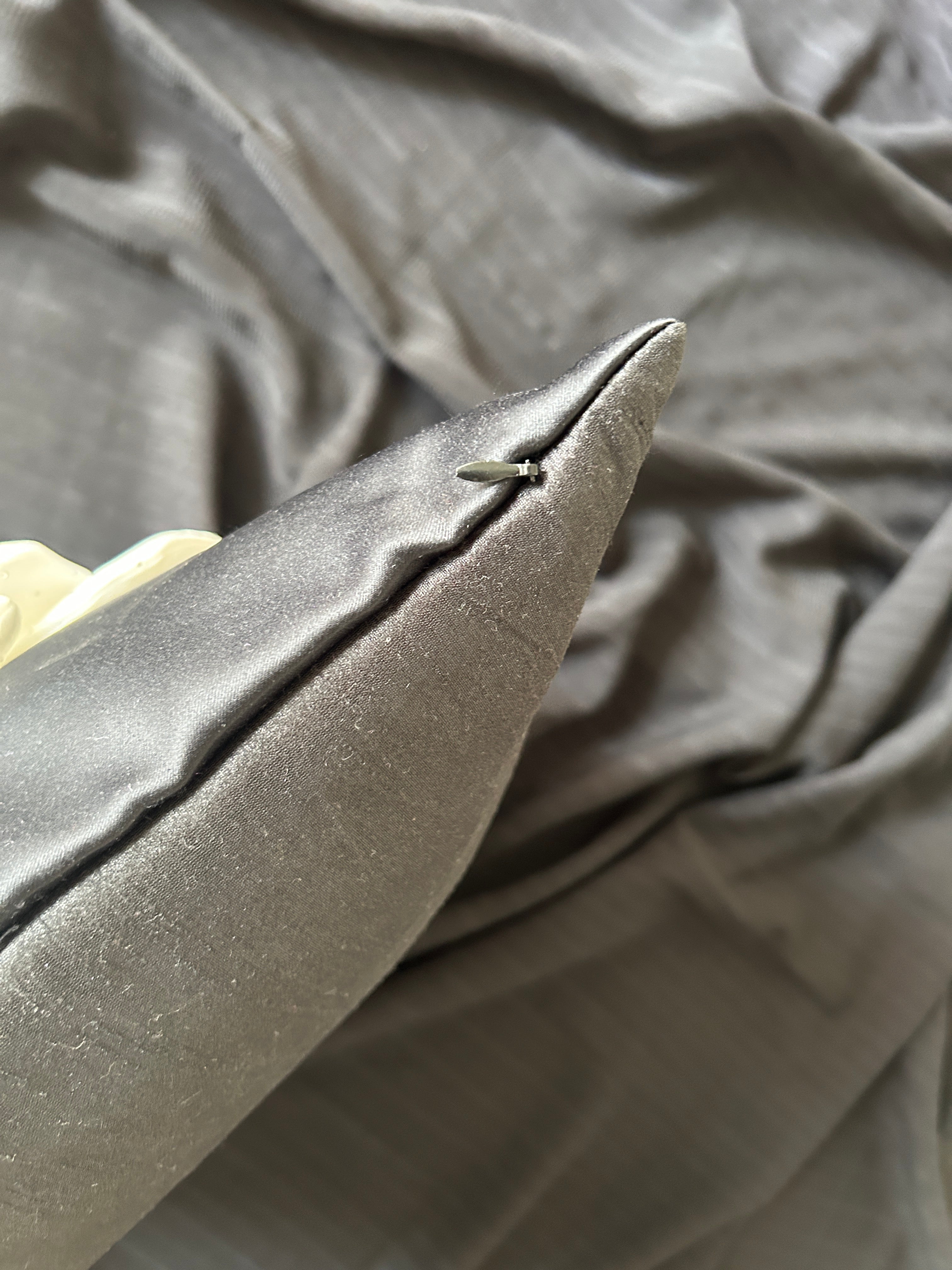 Close-up of a textured black fabric with a focus on a corner.